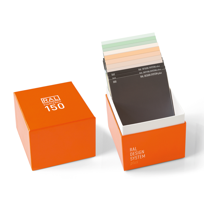 A range of paper colour samples from the RAL Design System Plus range, in a variety of shades shown inside its RAL Starter Kit box.