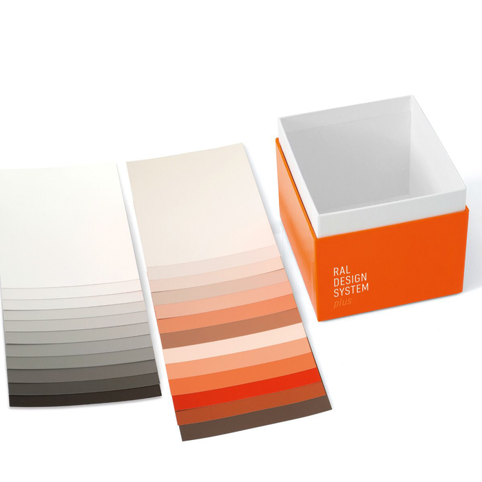 The RAL Starter Kit box shown with a range of paper colour samples from the RAL Design System Plus range, in a variety of shades.