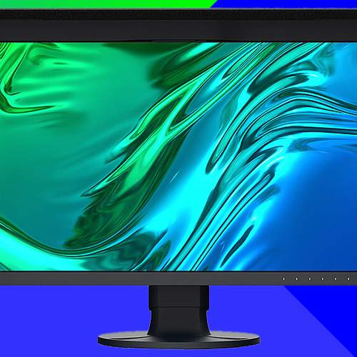 Black-framed computer monitor on a stand displaying an abstract, fluid pattern in green, teal, and blue tones, set against a geometric blue and green gradient background.