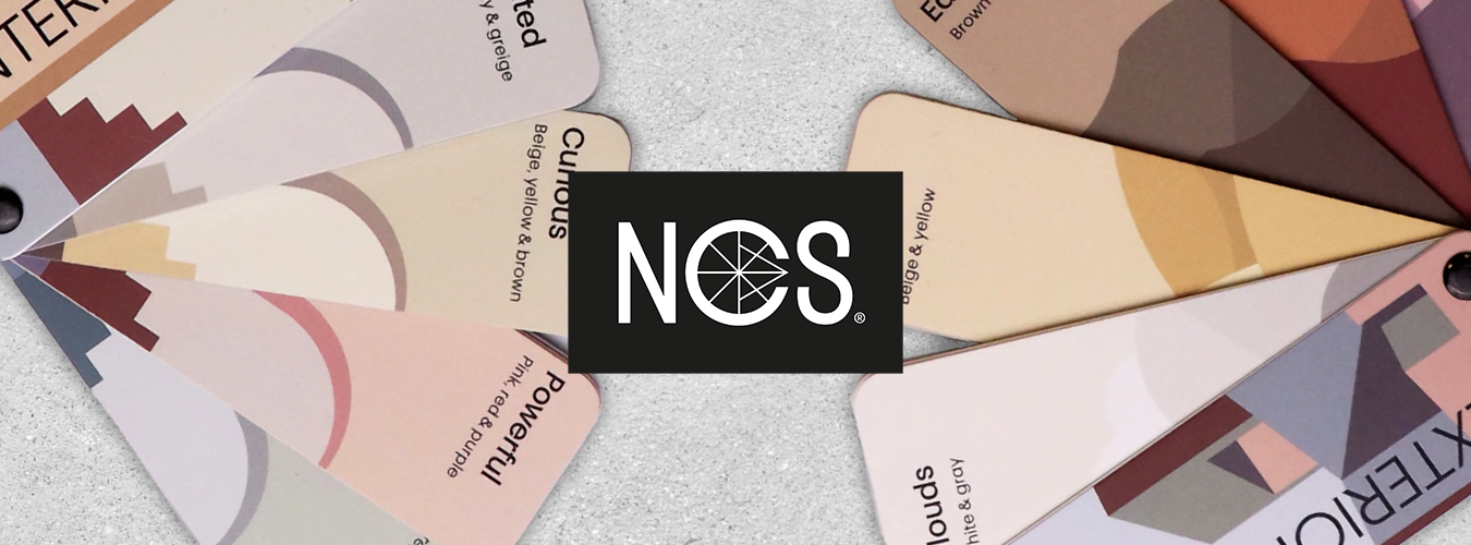A set of fan-shaped color sample cards with abstract geometric designs in muted tones arranged around a central black square featuring the white NCS logo.