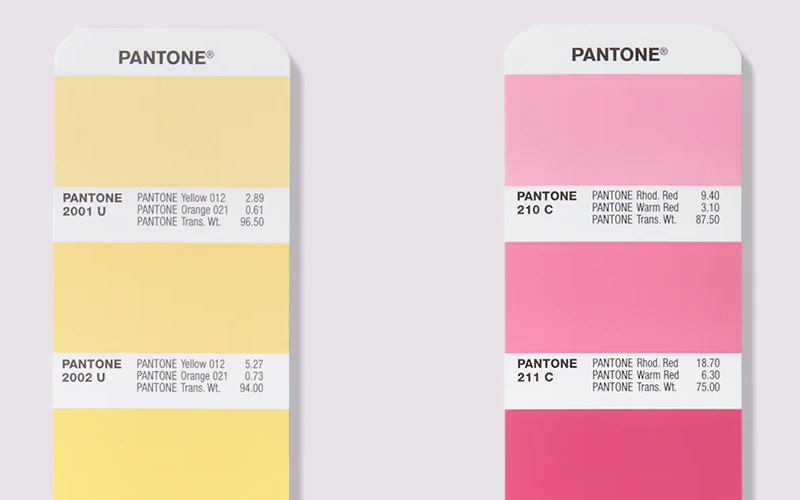 A close up of the PANTONE Formula Guide showing colour swatches, their corresponding PANTONE codes and the solid ink colour formulations for printing.