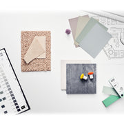 An example of the NCS ATLAS 2050 being used for colour selection and comparison, with the guide being cross referenced against colours for carpet, fabrics and other materials. Each colour is represented on a mounted colour chip within the colour reference book.