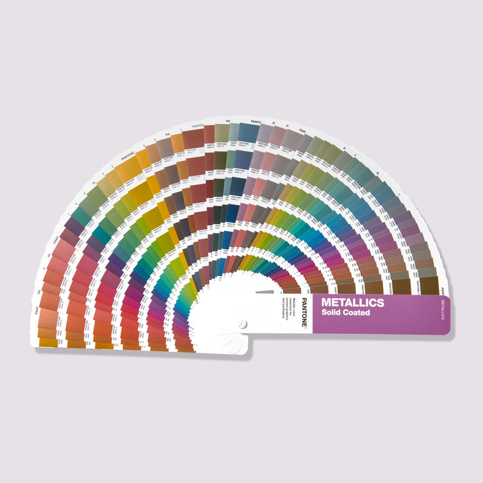 PANTONE Metallics Solid Coated Guide shown fanned out with paper metallic colour samples arranged in a semi circle.